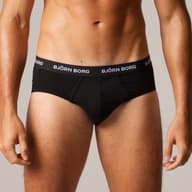 Man wearing black Björn Borg briefs, focusing on the waistband with branding, against a neutral background.