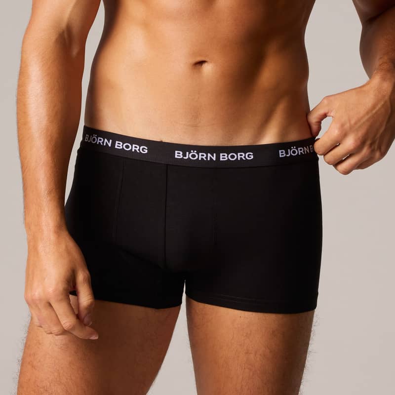Man wearing black Björn Borg boxer briefs with visible waistband branding, standing against a plain background.