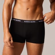 Man wearing black Björn Borg boxer briefs with visible waistband branding, standing against a plain background.