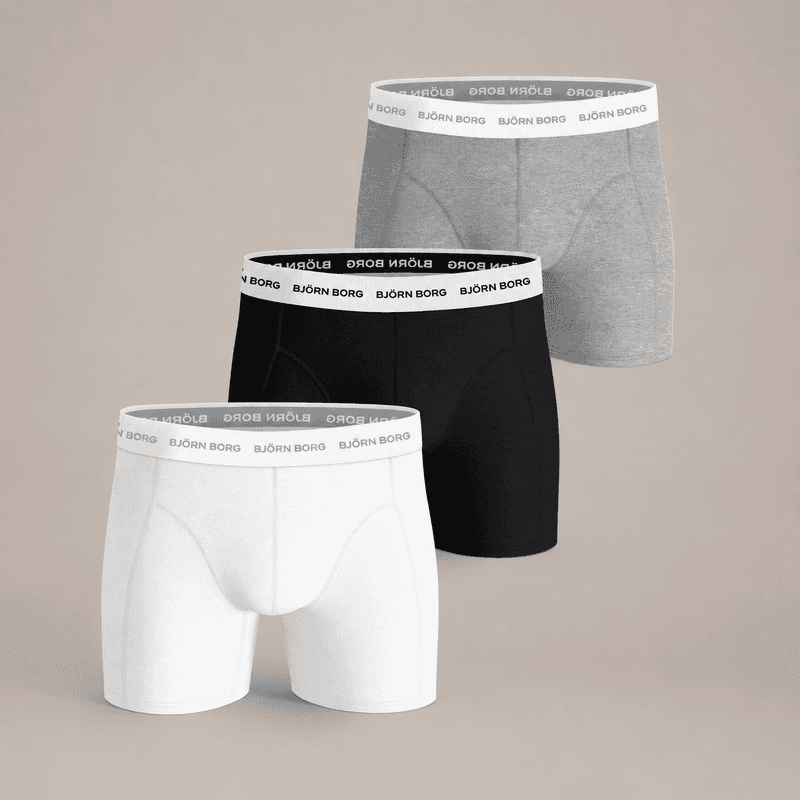 Three pairs of men's boxer briefs in white, black, and gray with branded waistbands on display against a neutral background.