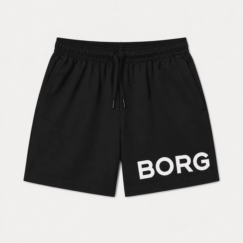 Kids' black sports shorts with elastic waistband, adjustable drawstring, side pockets, and large white logo print on the leg.