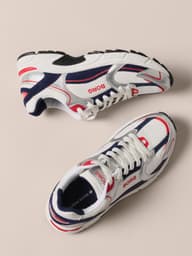 White, navy and red retro running sneakers shown from multiple angles.