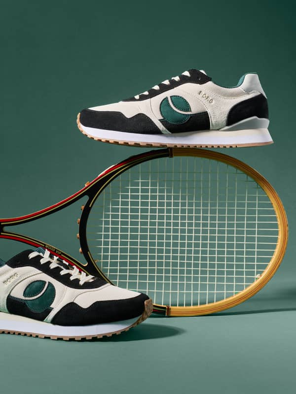 Retro running sneakers displayed with vintage tennis racket.