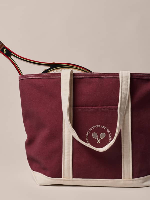 Maroon tote bag with cream handles, a tennis racquet peeking out, and "Borg Sports and Racquet" logo on front.