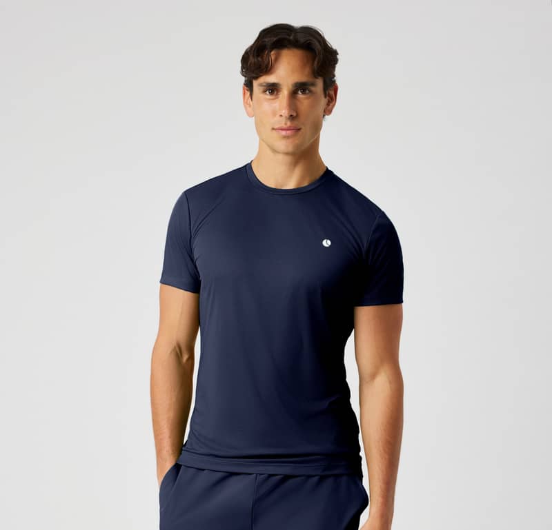 Male model wearing a navy blue Björn Borg performance T-shirt and matching shorts.