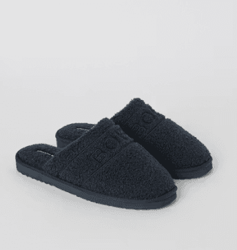 Pair of dark blue fleece slippers with open backs and textured surface, displayed on a light gray background.
