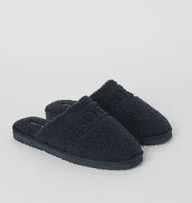 Pair of dark blue fleece slippers with open backs and textured surface, displayed on a light gray background.