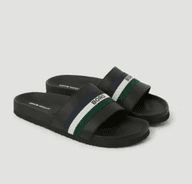Black slide sandals with a wide strap featuring blue, white, and green stripes, and "BORG" text.