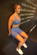 Woman doing wall sit exercise at the gym