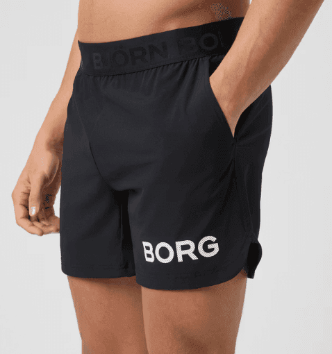 A person wearing black shorts with "BORG" printed on the leg and hands in pockets. The waistband has "BJÖRN BORG" written on it.