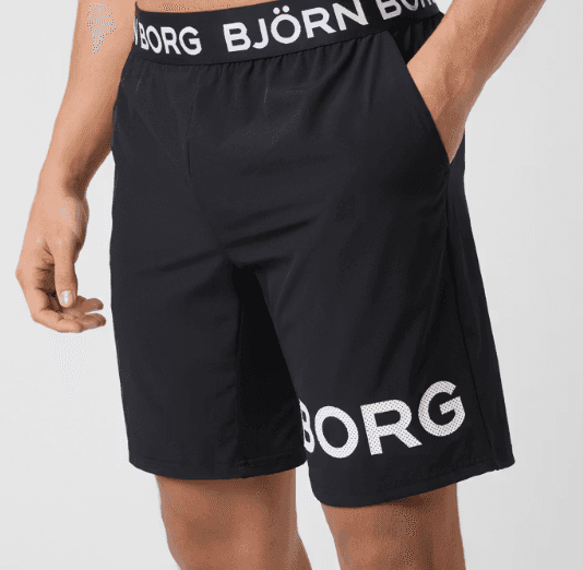 A person wearing black athletic shorts with "BJORG" written on them and an elastic waistband featuring "BJÖRN BORG" branding.