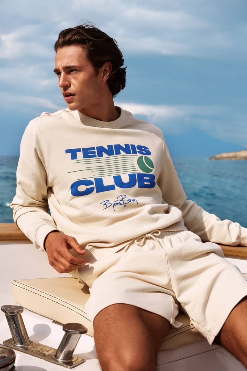 Man wearing beige Björn Borg Tennis Club sweatshirt on boat