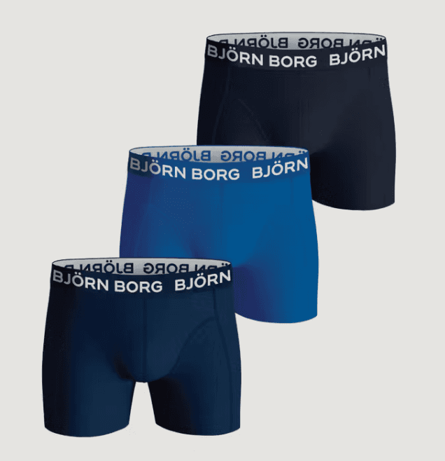 Three pairs of men's boxers in navy, blue, and black, featuring branded waistbands.