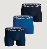 Three pairs of men's boxers in navy, blue, and black, featuring branded waistbands.