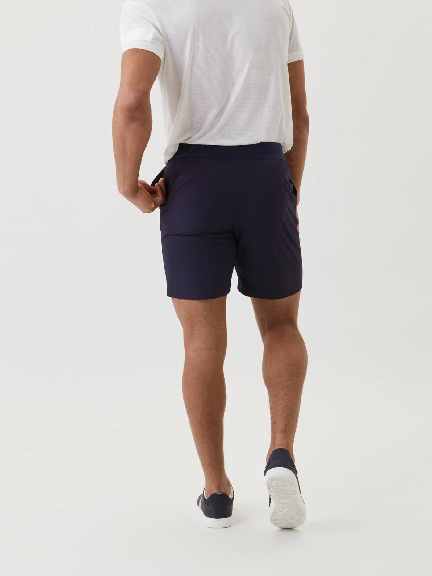 Back view of a man wearing the Borg Shorts in Navy, highlighting the functional 9-inch length and fit for training. - Image 3