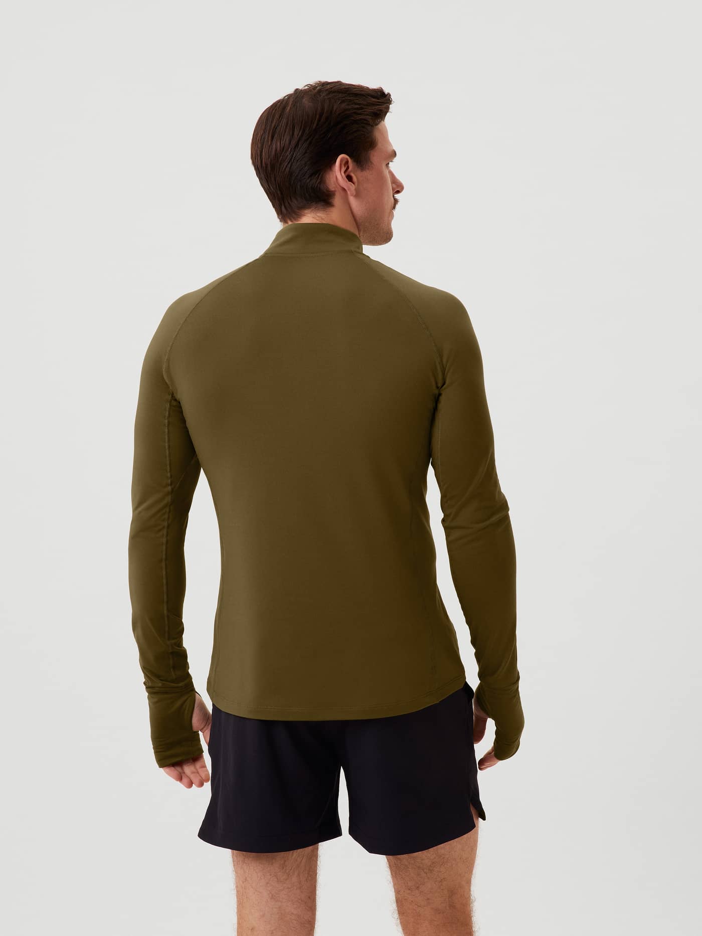 Achteraanzicht van een man in de functionele Borg Midlayer Half Zip in Dark Olive (Groen) met duimgaten voor training. - Image 4