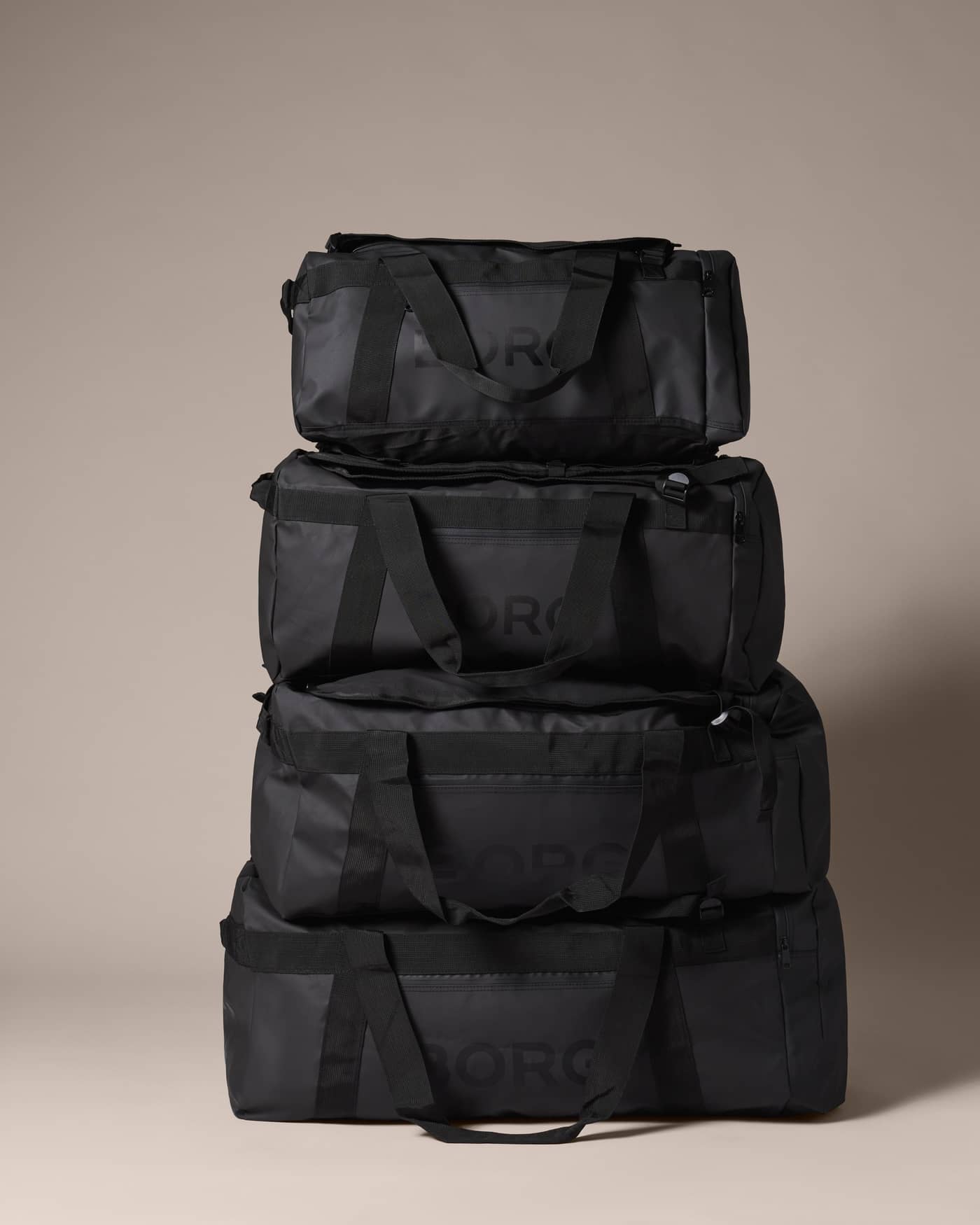 Stacked black Borg Duffle Bag 35L crafted from durable coated recycled polyester for gym and training. - Image 2