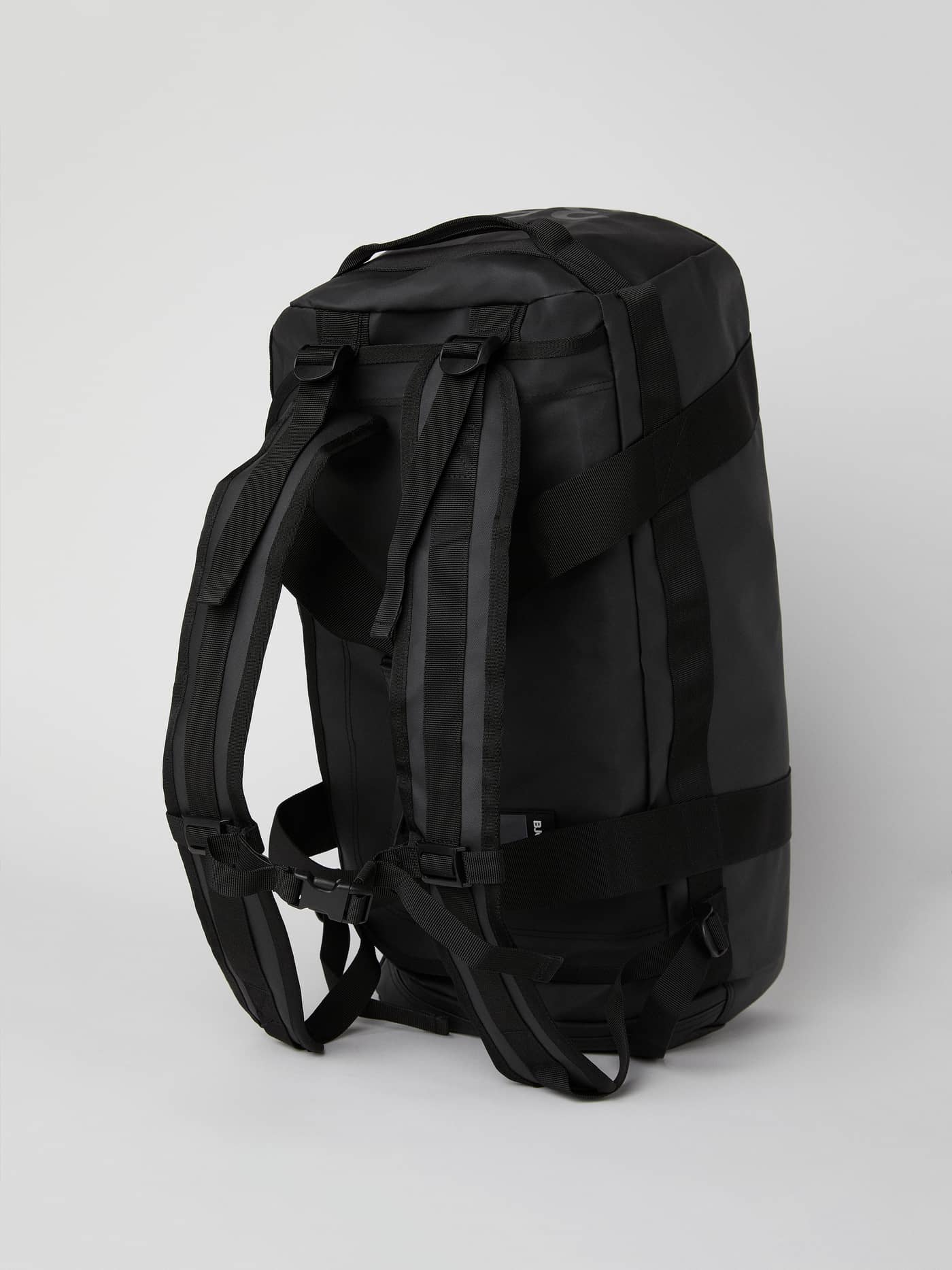 Angled back view of the black Borg Duffle Bag 35L showcasing the adjustable backpack straps and durable TPE coating. - Image 5