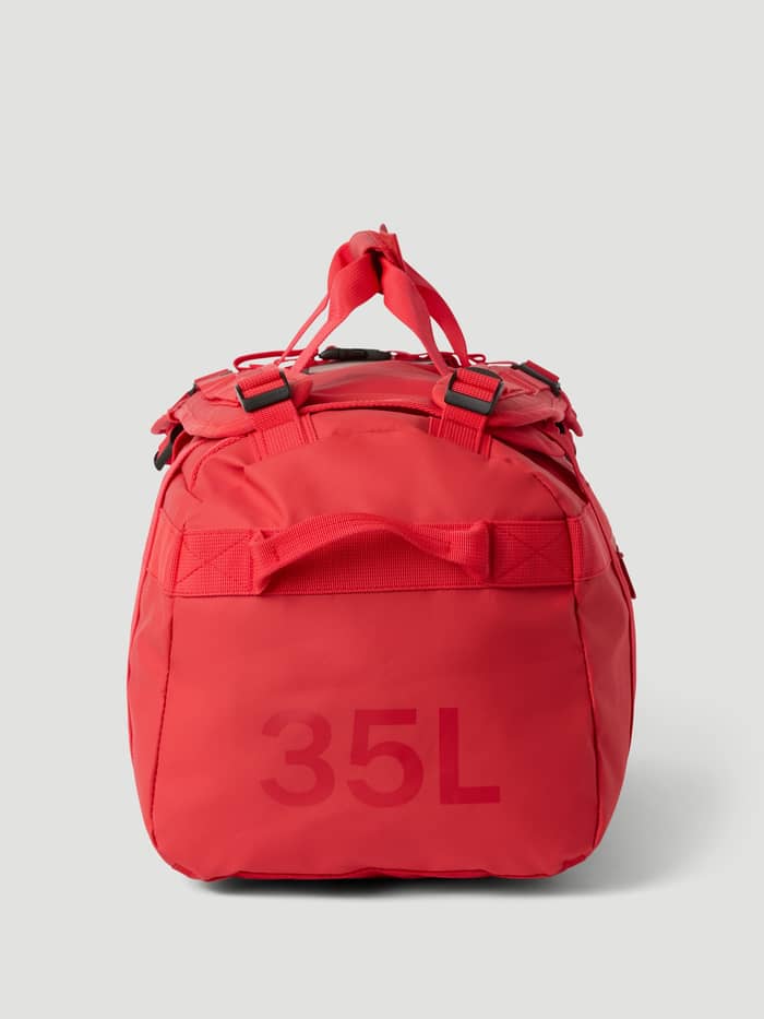 Side view of the Samba (Red) Borg Duffle Bag 35L, showcasing its sturdy coated material and the 35L capacity detail. - Image 4