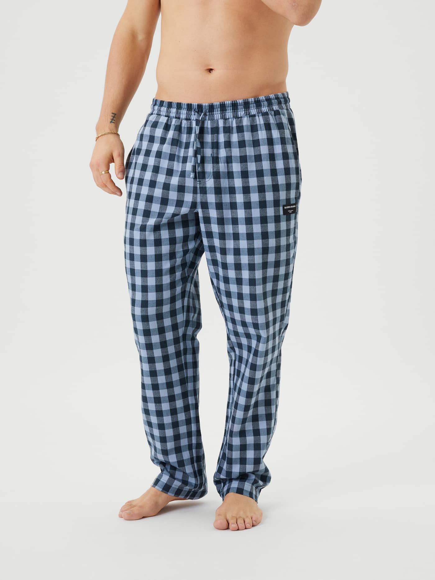 Front view of a model wearing the Björn Borg Core Flannel Pyjama Pants in a blue checkered pattern. - Image 2