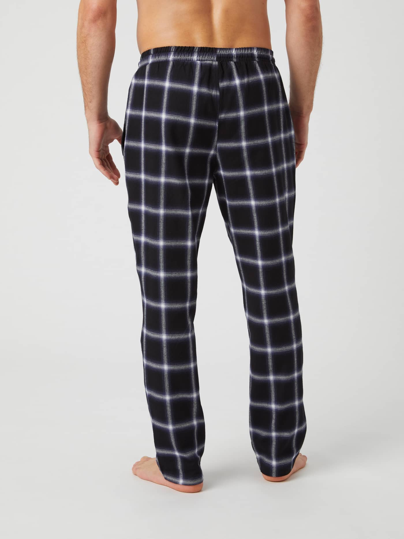 Back view of a model wearing Björn Borg Core Flannel Pyjama Pants in a black and white check pattern. - Image 3
