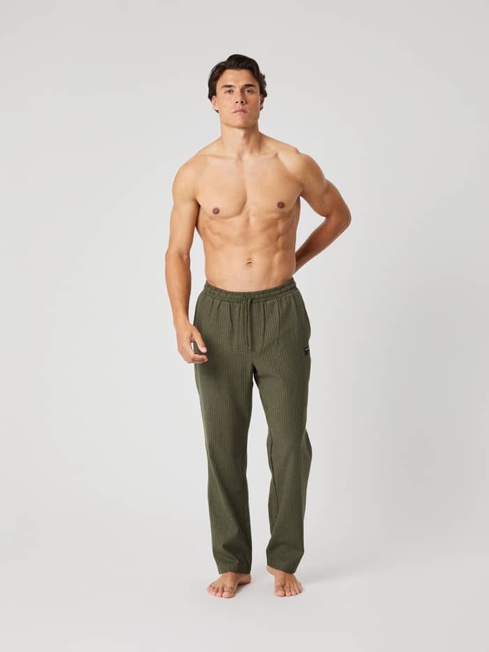 Front view of a model wearing the Björn Borg Core Flannel Pyjama Pants in a green mini check pattern.
