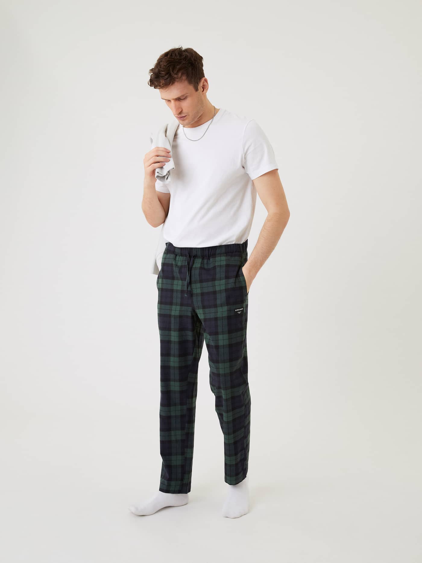 Model from the front wearing Björn Borg Core Flannel Pyjama Pants in a green and navy plaid pattern. - Image 1