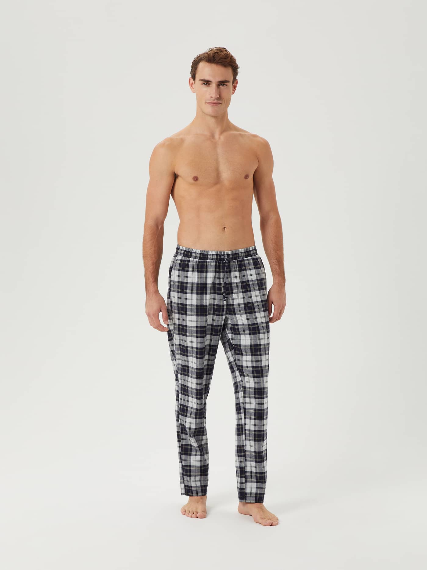 Front view of a model wearing Björn Borg Core Flannel Pyjama Pants in a black and white tartan pattern. - Image 3