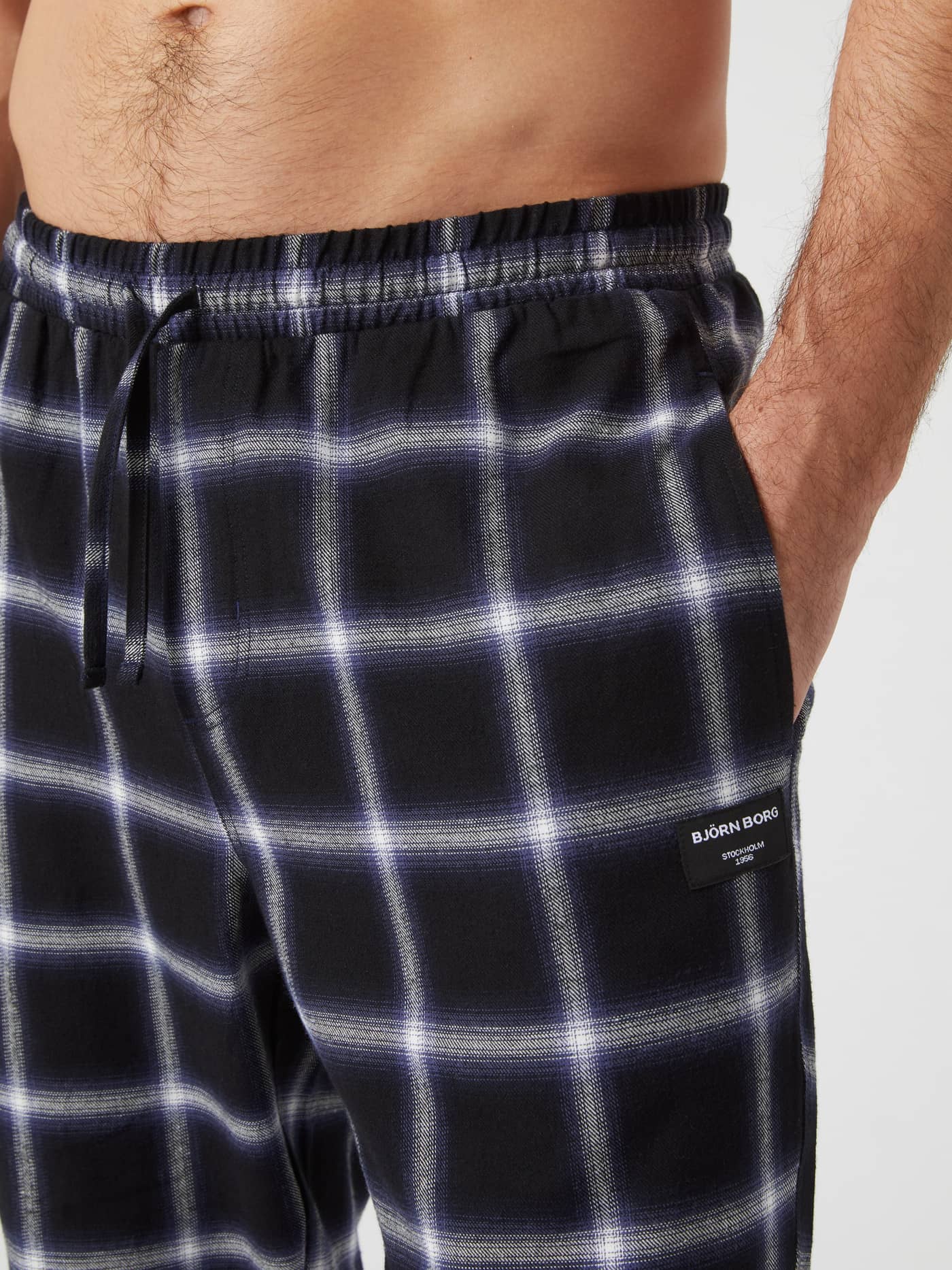 Close-up of Björn Borg Core Flannel Pyjama Pants in black check, showing the elastic waistband, drawstring, and side pocket. - Image 4