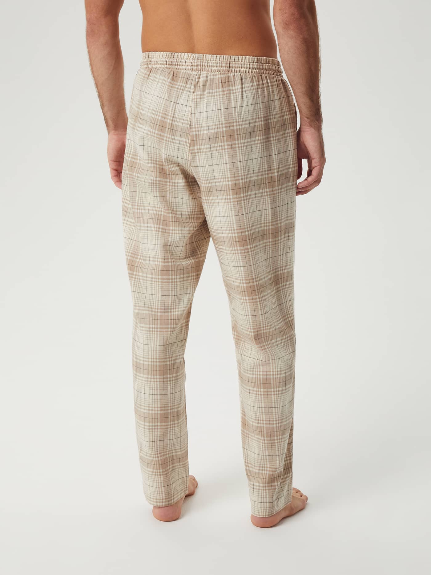 Back view of a model wearing the Björn Borg Core Flannel Pyjama Pants in a beige plaid pattern against a white background. - Image 2