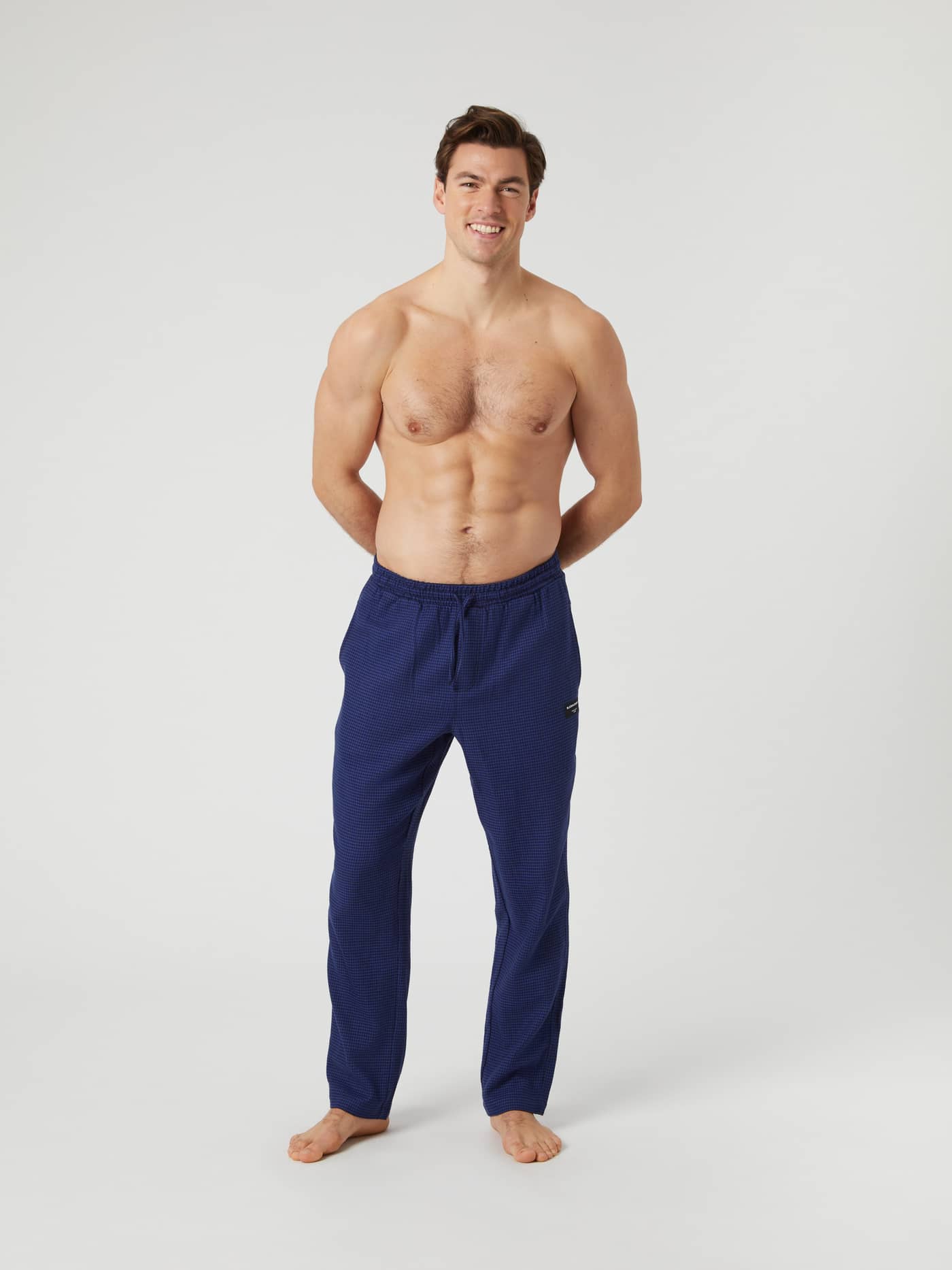 Full-length front view of a shirtless model wearing blue Björn Borg Core Flannel Pyjama Pants. - Image 1