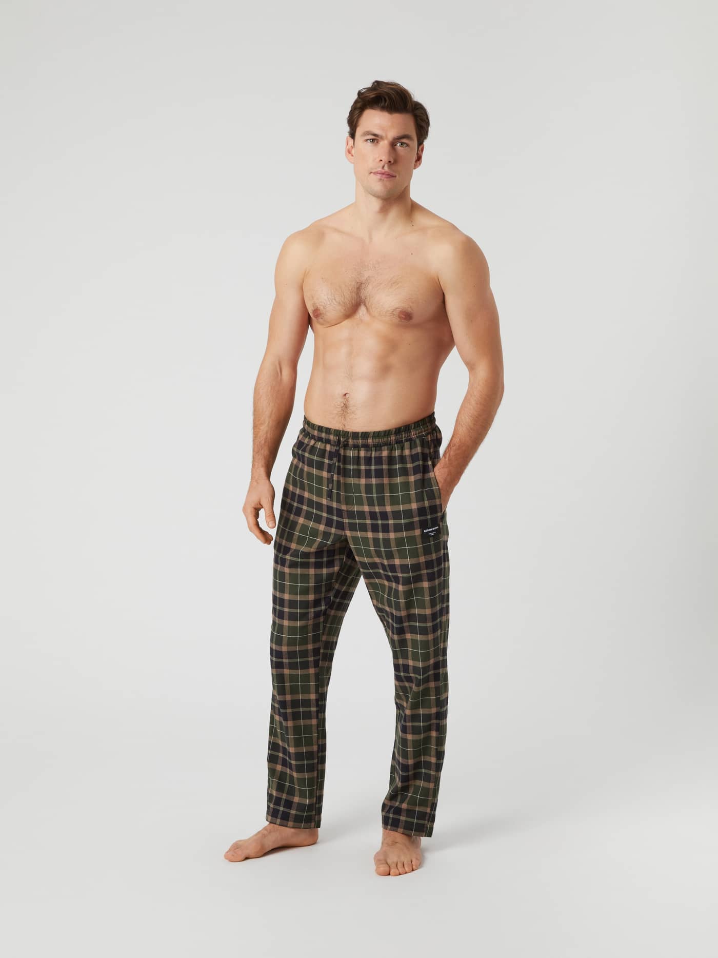Full-length studio shot of a male model wearing the Björn Borg Core Flannel Pyjama Pants in a green and black Gaelic Tartan. - Image 3