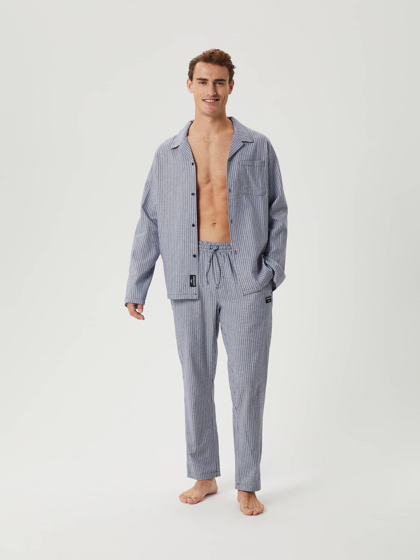 Front view of model wearing Björn Borg Core Flannel Pyjama Pants in a blue mini check pattern with matching shirt. - Image 1