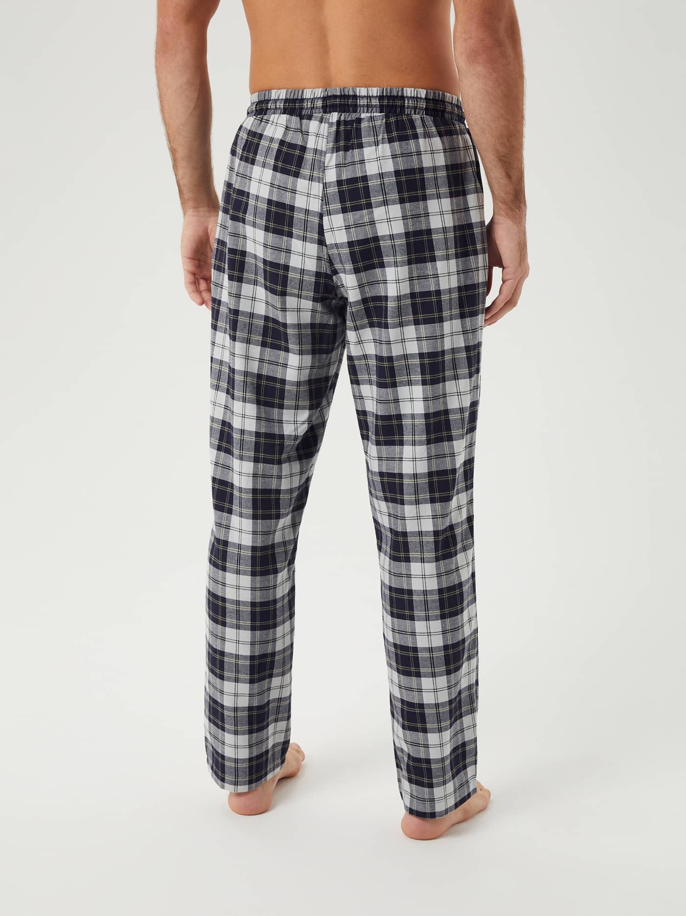 Back view of a man wearing Björn Borg Core Flannel Pyjama Pants in a black and white tartan print. - Image 2