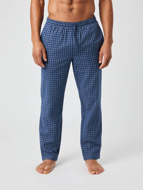 Front view of a model wearing the Björn Borg Core Flannel Pyjama Pants in a blue multicheck pattern.