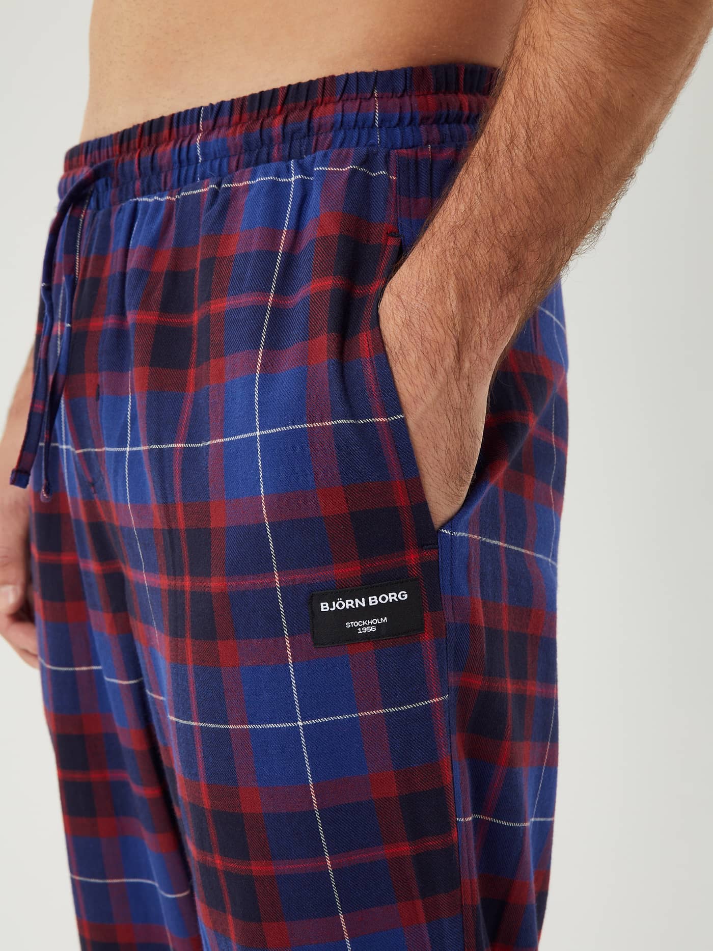 Close-up of the Björn Borg Core Flannel Pyjama Pants in a blue and red tartan print, showing the pocket and logo detail. - Image 1