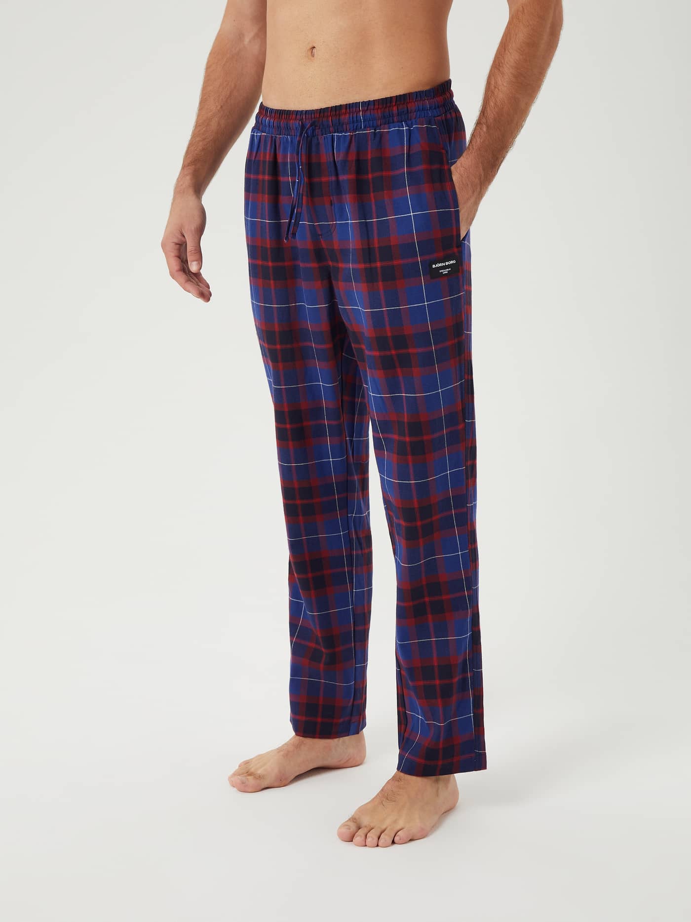 Model wearing the Björn Borg Core Flannel Pyjama Pants in a blue and red Gaelic Tartan print, shown from the side. - Image 2