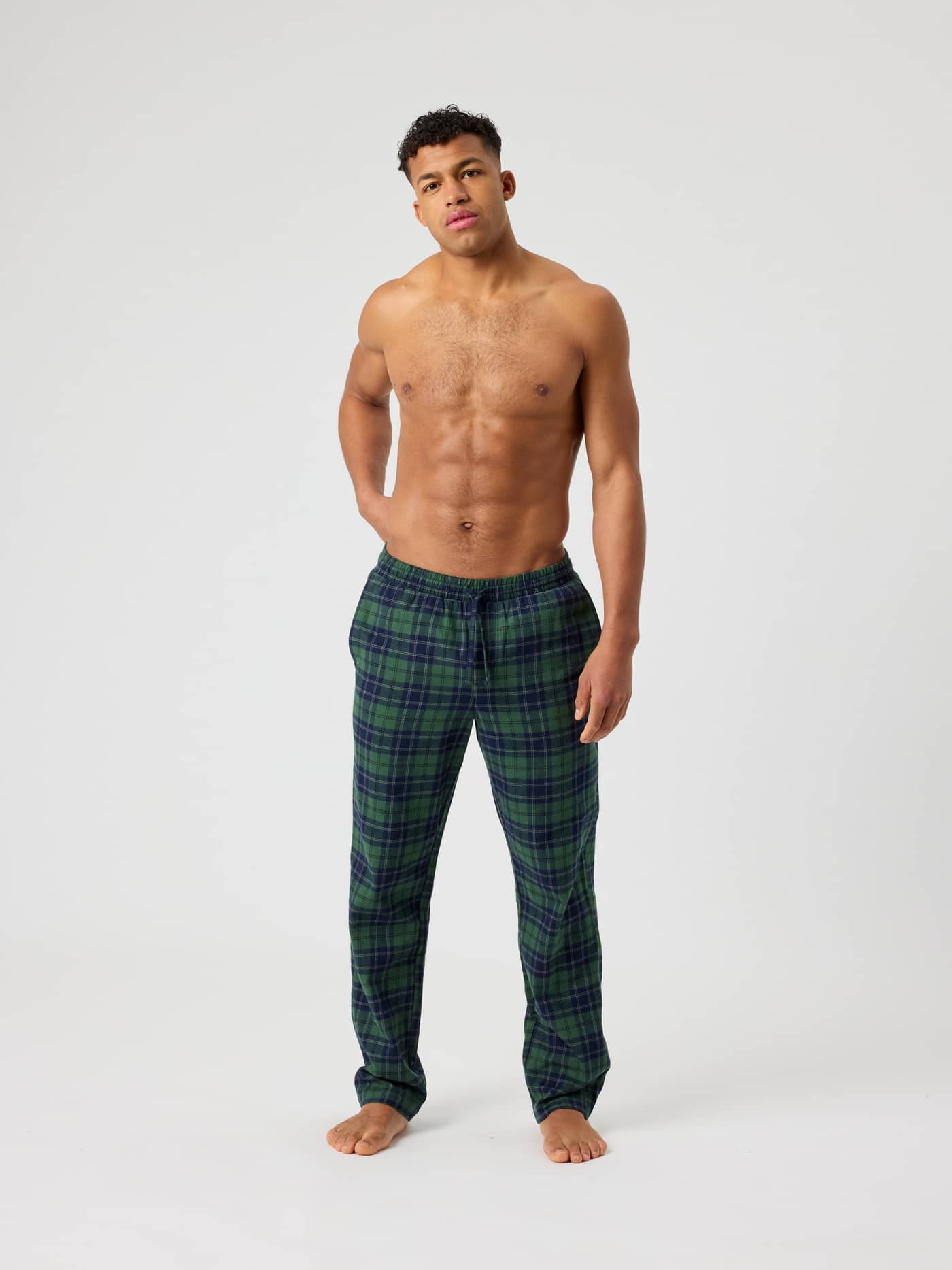 Front view of a man wearing Björn Borg Core Flannel Pyjama Pants in Forest Tartan 7 (Green) with a classic tartan pattern. - Image 3