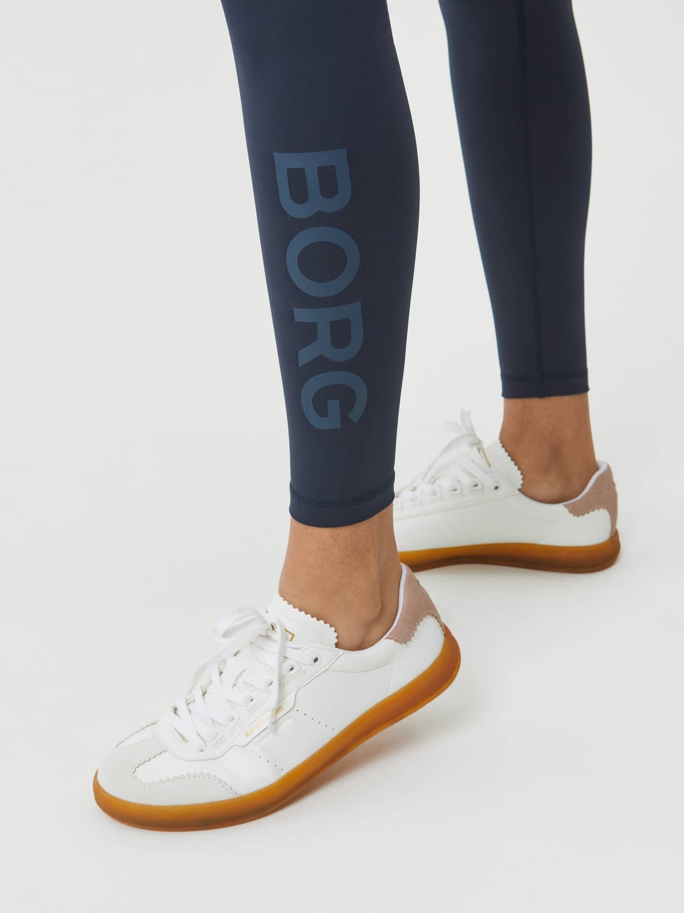 Close-up of the vertical tonal logo on the Borg Logo Tights in Outerspace (Blue), offering a stylish fit for training. - Image 4