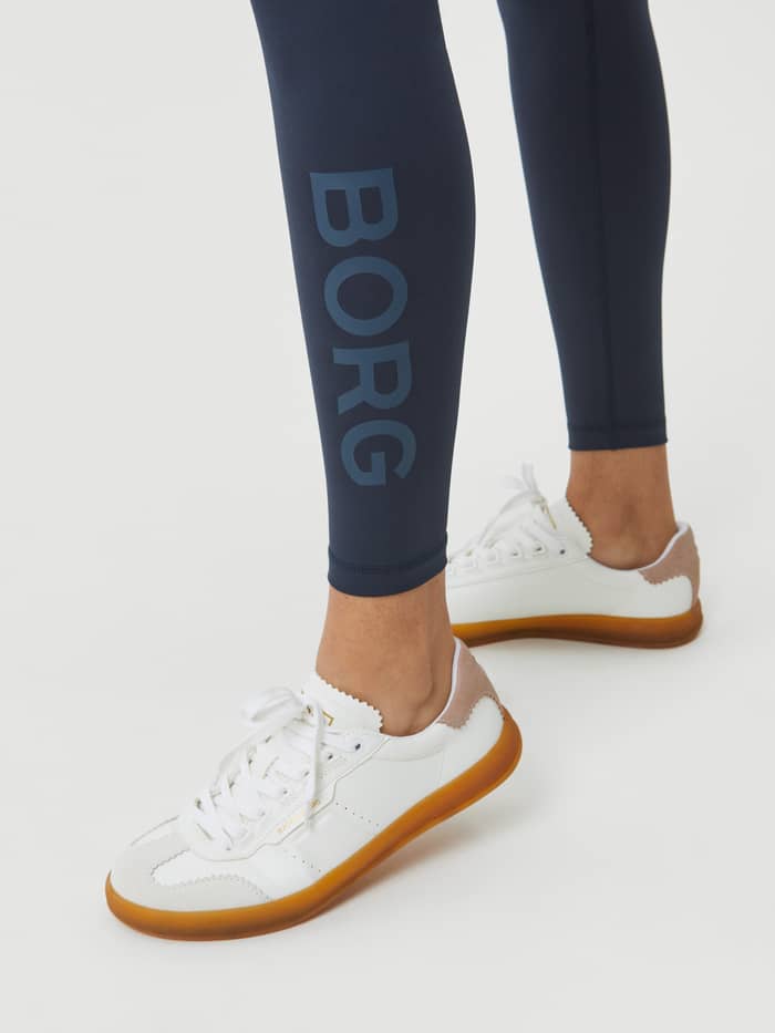 Close-up of the vertical tonal logo on the Borg Logo Tights in Outerspace (Blue), offering a stylish fit for training. - Image 4