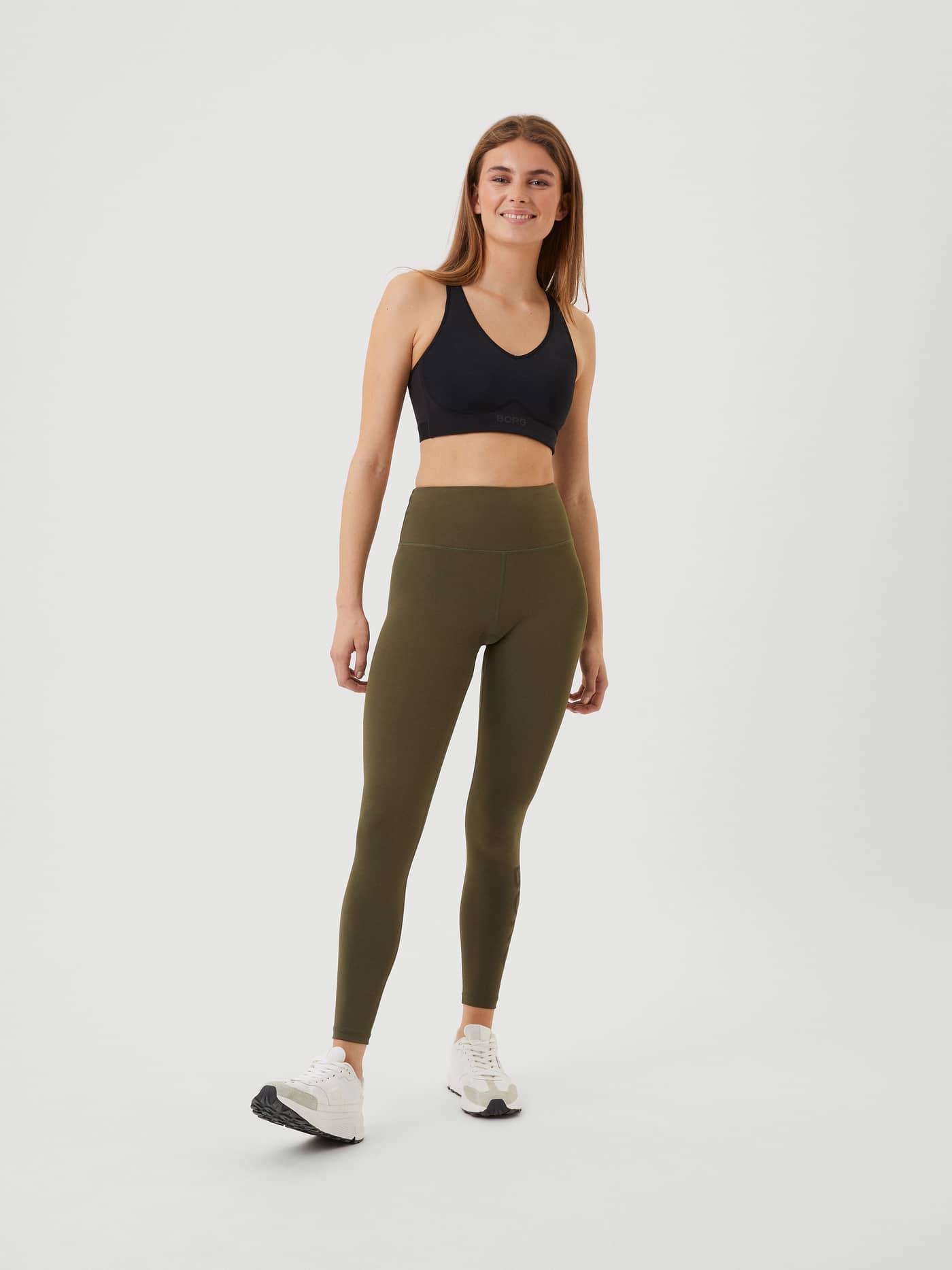 Full-body front view of a model wearing high-waist Borg Logo Tights in Olive Night (Green) for training. - Image 1