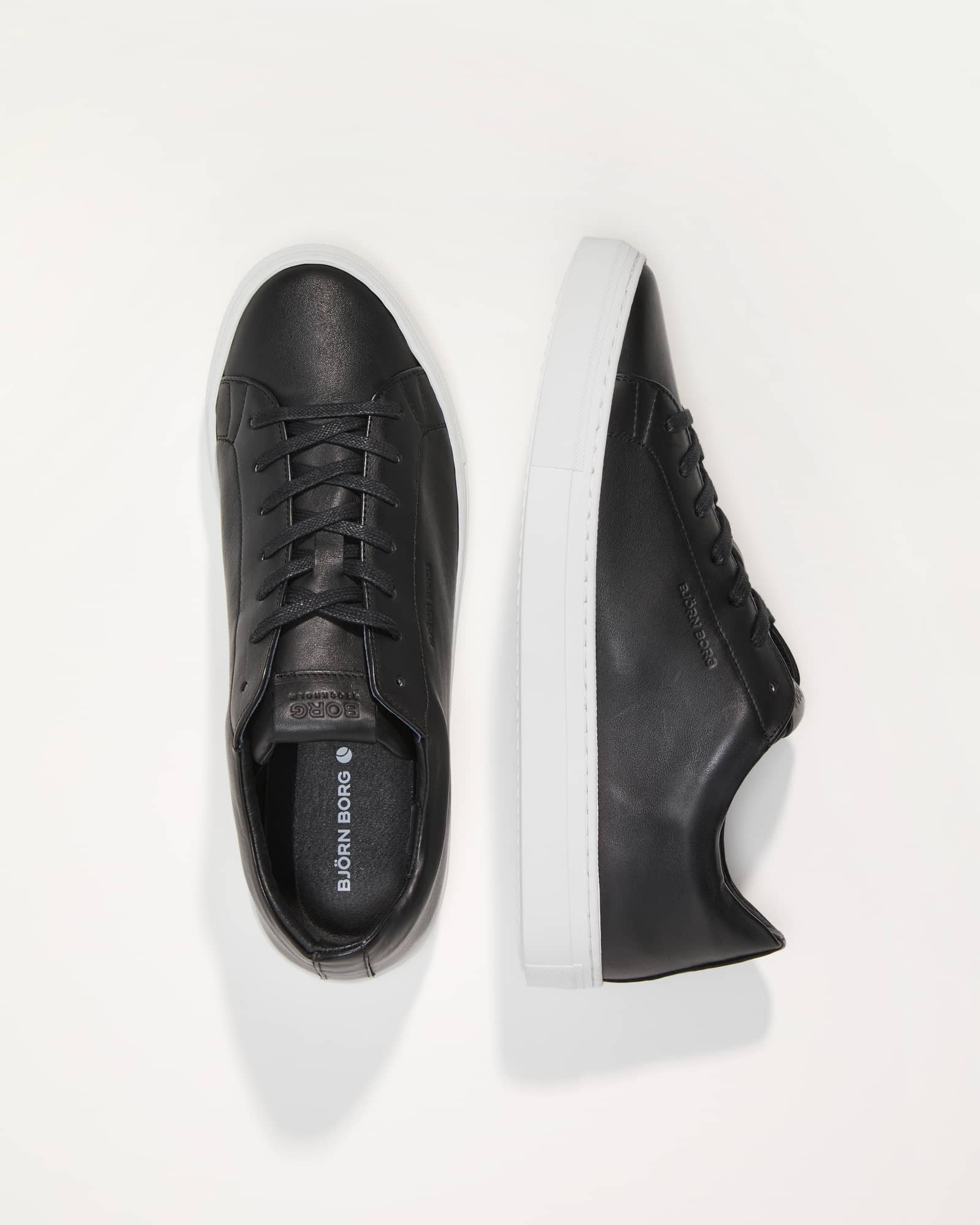 Top-down view of the black Björn Borg CLASSIC (SL100) LEA M leather sneakers featuring white soles and tonal laces. - Image 1