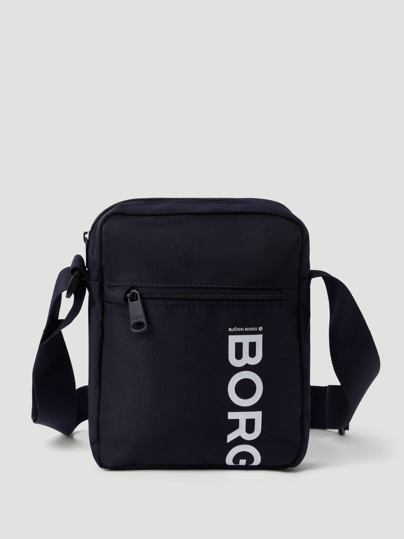 Core Crossover Bag 1,7L i Night sky (Marineblå) sett forfra med hvit BORG-logo og justerbar skulderrem. - Image 1
