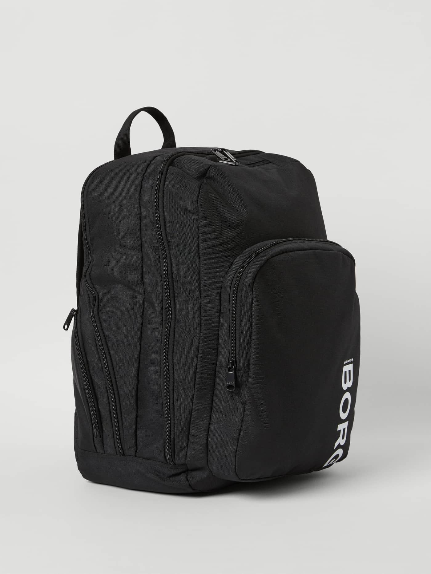 Front side view of the black Björn Borg Core Curve Backpack 27L with a white BORG logo. - Image 1