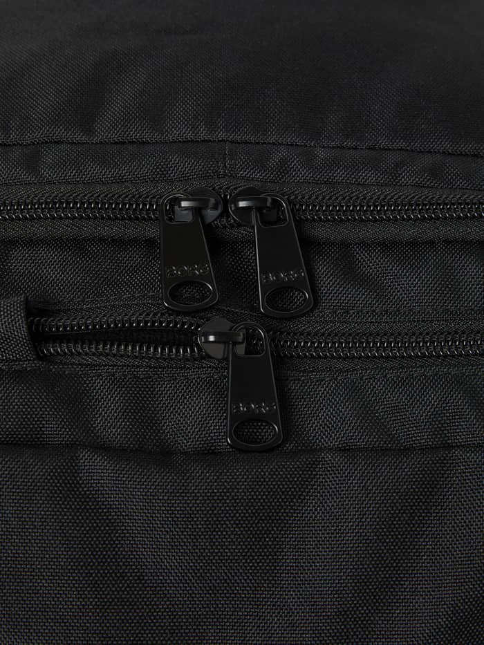 Detailed close-up of the black zippers and embossed logos on the Core Curve Backpack 27L in Black Beauty (Black). - Image 4