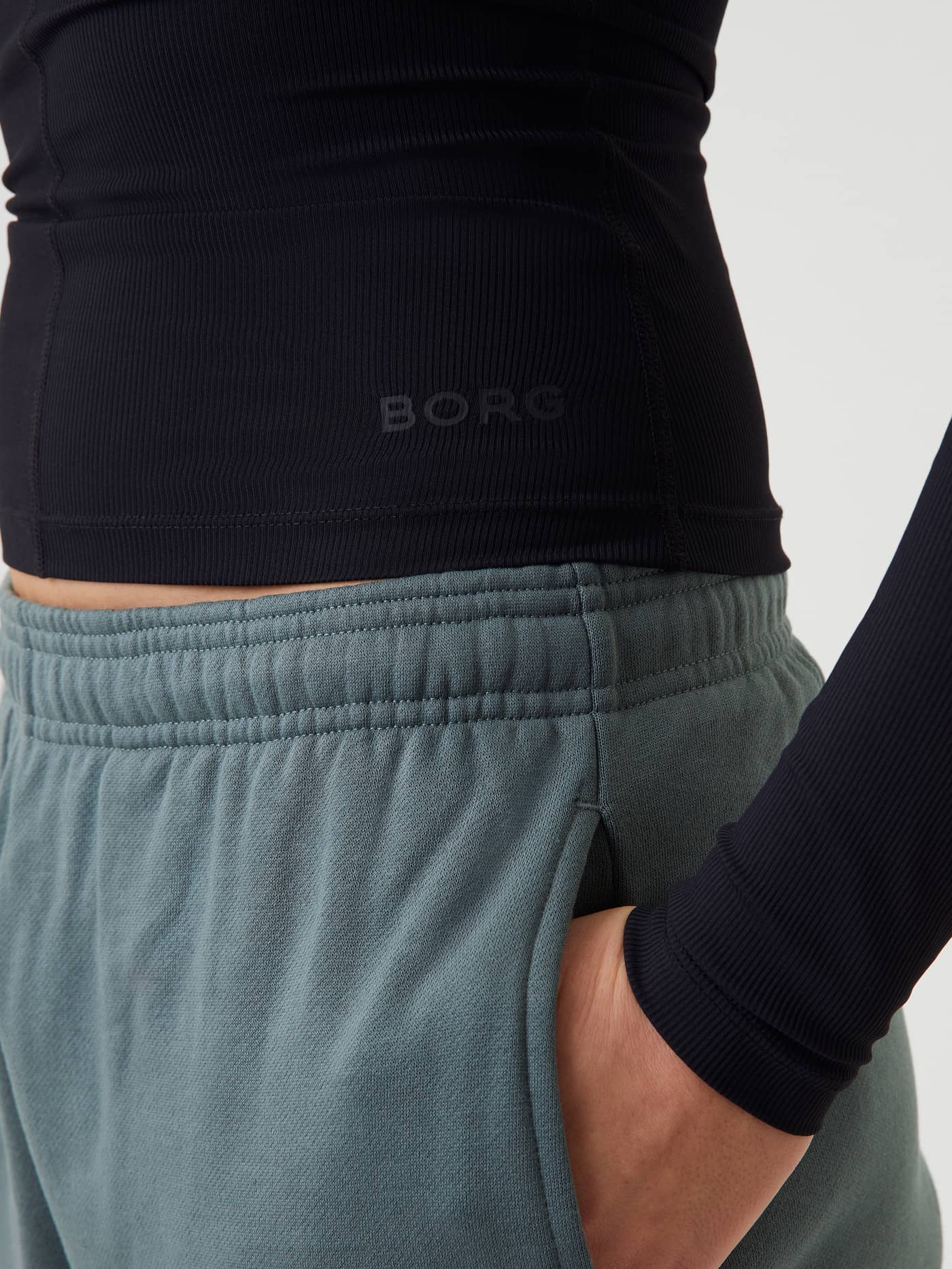 Close-up of the Studio Ballerina Long Sleeve in Black Beauty (Black) featuring a tonal black BORG logo on the hip. - Image 5