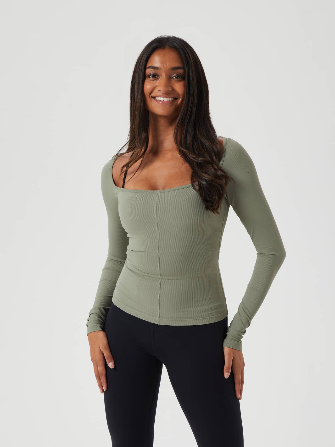 Front view of a model wearing the slim-fit Björn Borg Studio Ballerina Long Sleeve in Vetiver (Green) for training. - Image 1