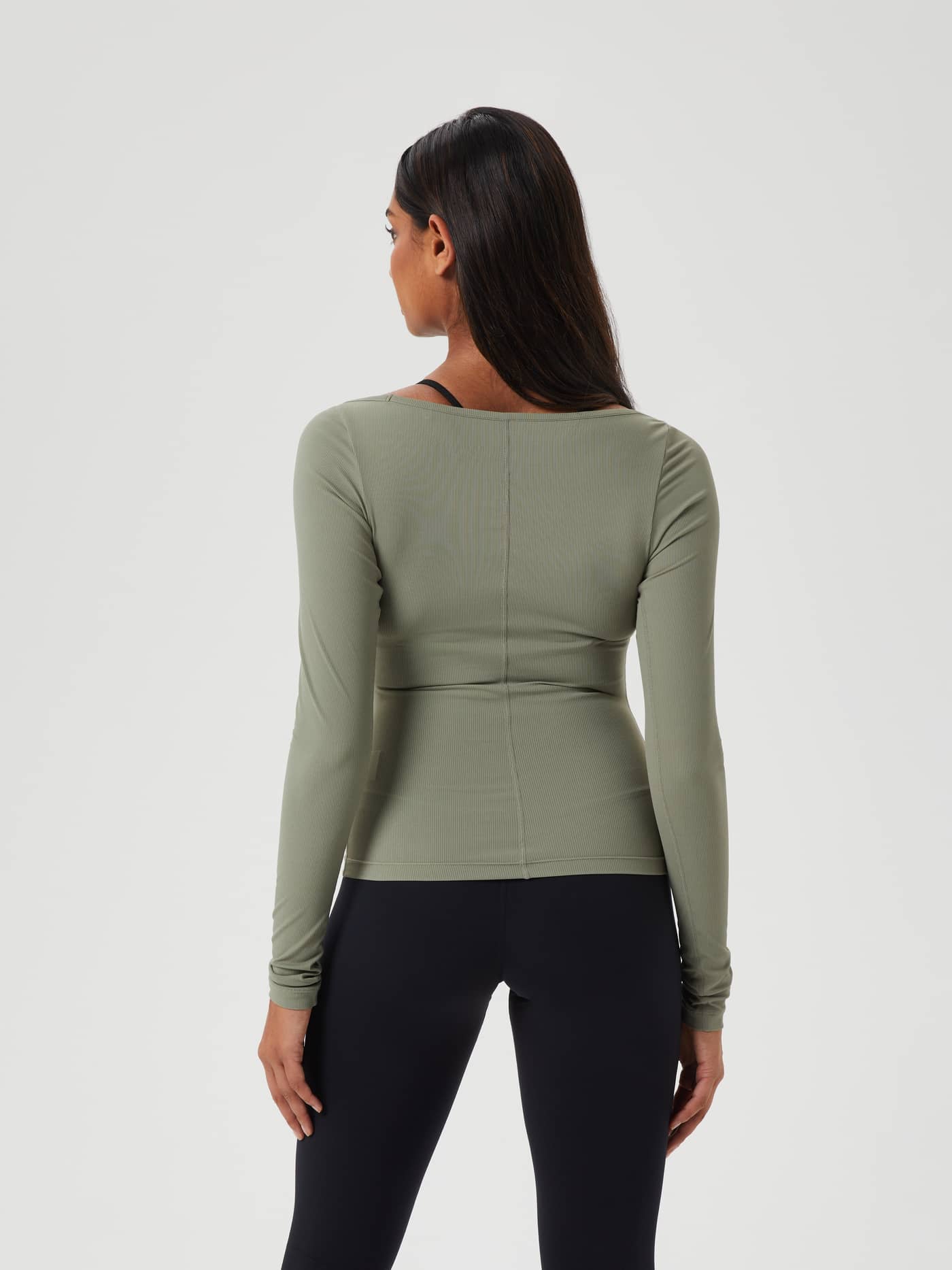 Back view of a model wearing the slim-fit Björn Borg Studio Ballerina Long Sleeve in Vetiver (Green) for training. - Image 2