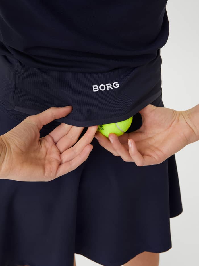 Ace Skirt Pocket in Navy für Tennis mit praktischer Balltasche hinten und weißem BORG-Logo. - Image 4