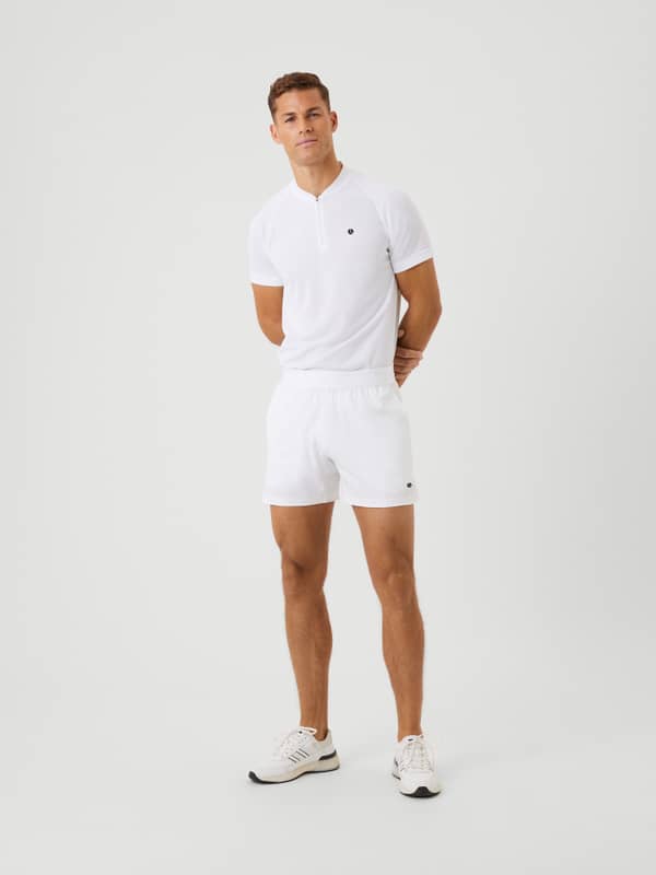 Full-body front view of a man wearing Björn Borg Ace Short Shorts in Brilliant White (White) with a black logo for tennis.
